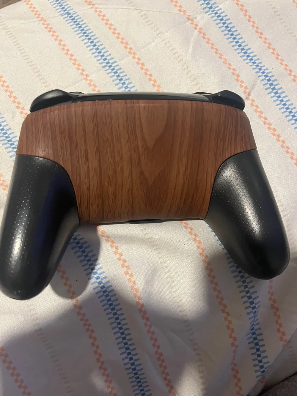 Nintendo Switch Pro Controller featuring a customized wood-grain